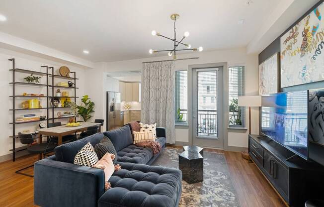 a living room with a blue couch and a tv