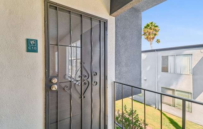 A glass door with a metal handle and a sign on the wall.