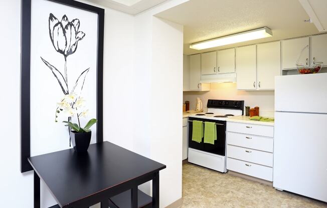 kitchen with white cabinets with black table