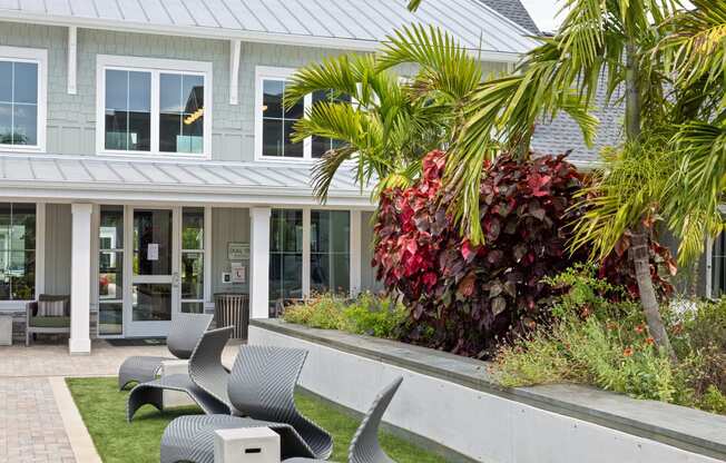 a patio with chairs in front of a house at Palm Grove in Ellenton, FL 34222