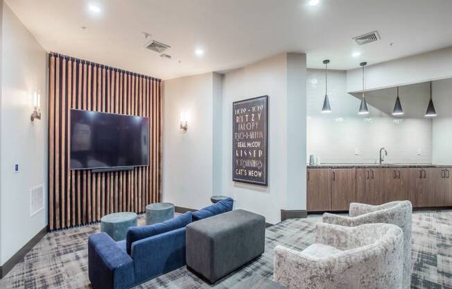 A living room with a flat screen TV and a carpeted floor.