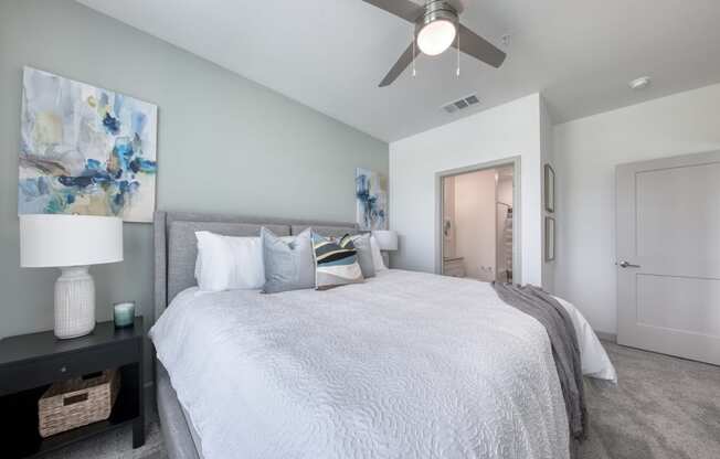 a bedroom with a large bed and a ceiling fan