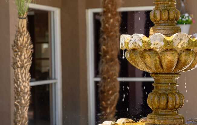 a fountain in front of a building at Oak Terrace Senior Apts, Hemet