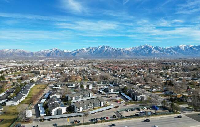 an aerial view of a city with mountains in the background