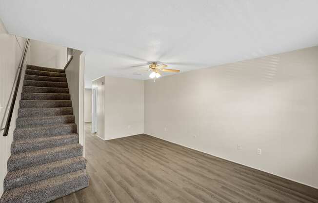 an empty living room with a staircase and a ceiling fan at Brookside Apartments, Hewitt, TX, 76643