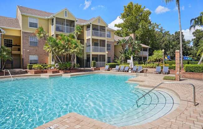 A swimming pool in front of a residential building.