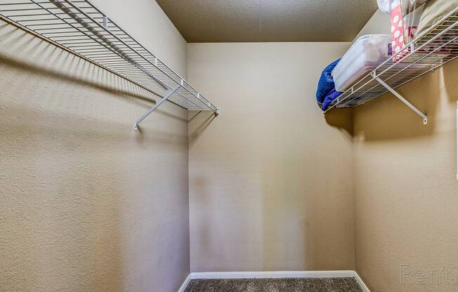 an empty closet with two closets and a rack on the wall