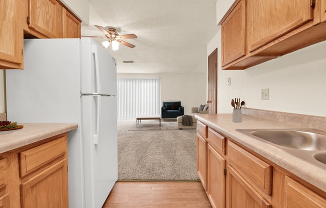 A kitchen with wooden cabinets and a white refrigerator.