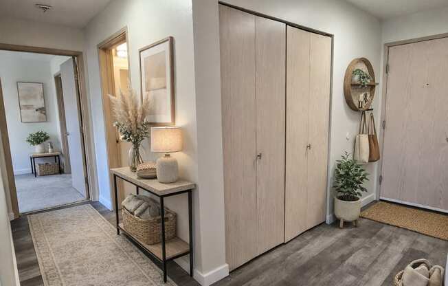 A hallway with a rug and a basket on the floor.