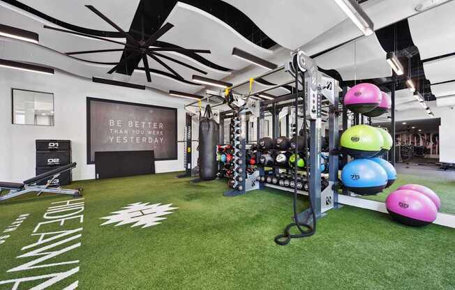A gym with a green floor and a sign that says