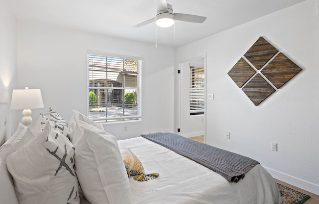 a bedroom with a large bed and a ceiling fan