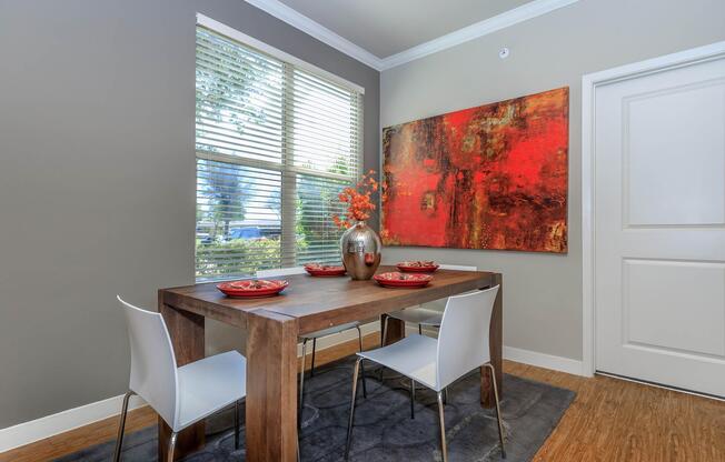 a living room with a table in front of a window