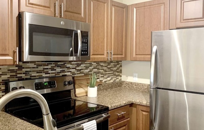 a kitchen with stainless steel appliances and granite counter tops