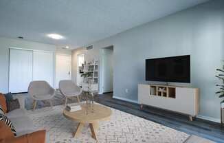 a living room with blue walls and a flat screen tv on the wall