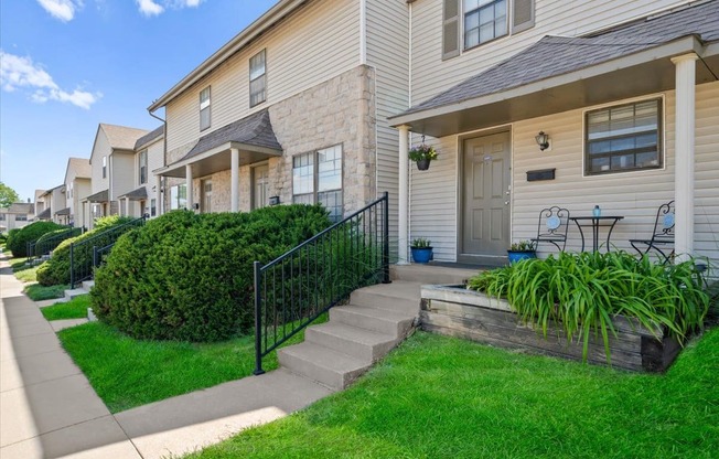 A row of houses with a green lawn in front.