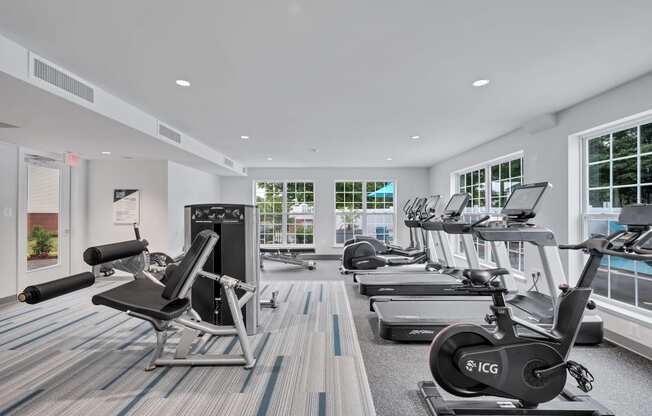 a gym with treadmills and other exercise equipment