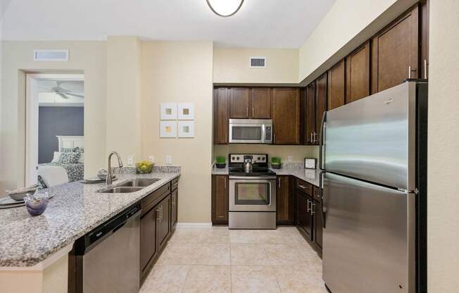 a modern kitchen with stainless steel appliances and granite counter tops