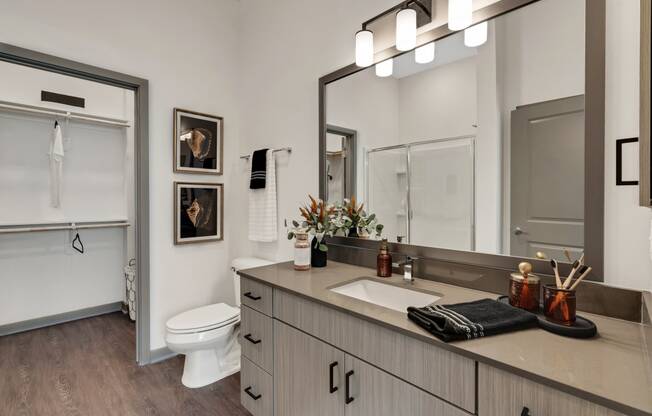 a bathroom with a large mirror and a white toilet  at The Sophia, Florida, 34275