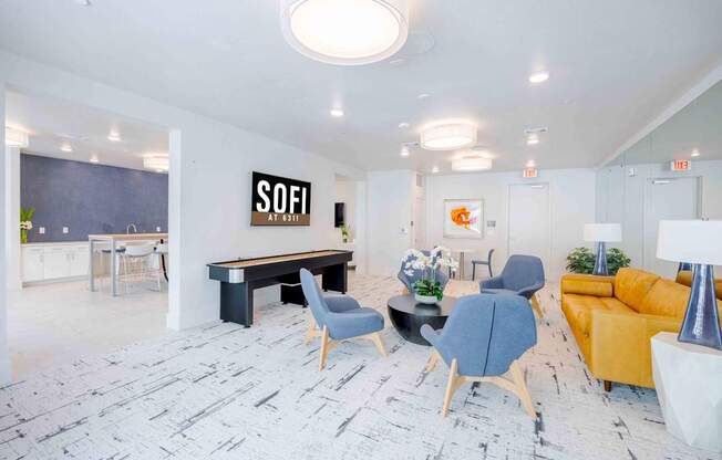 A modern office space with a pool table and comfortable seating.