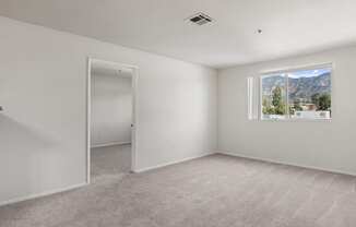 an empty room with white walls and a window with a mountain view at Dronfield Astoria California, 91342