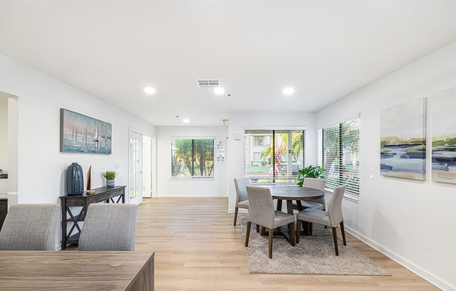 a living room with a dining room table and chairs