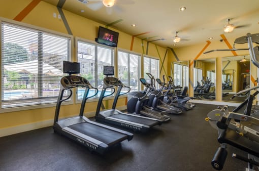 Fitness room fully equiped with cardio and strength machines as well as free weights at Ashley Auburn Pointe in Atlanta, GA