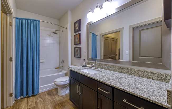En-suite Bathrooms with Granite Countertops at 4700 Colonnade Apartments in Birmingham, AL