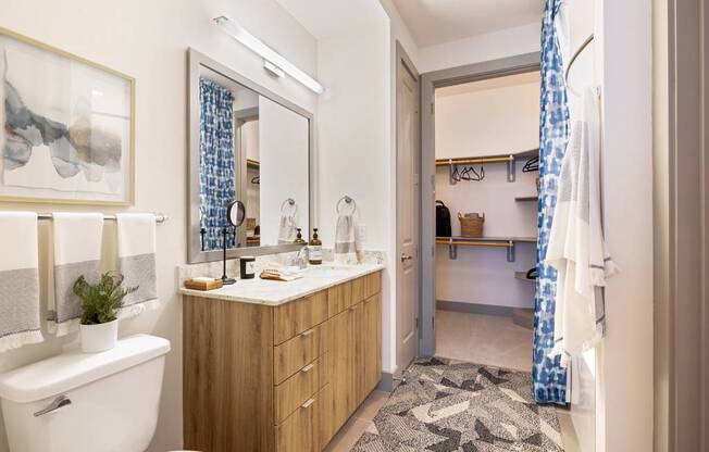 a bathroom with a toilet and a sink and a shower