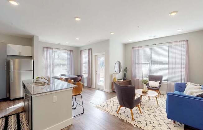 a living room with a kitchen and a dining room at Echo Park at Perry Crossing Apartments, Plainfield, IN
