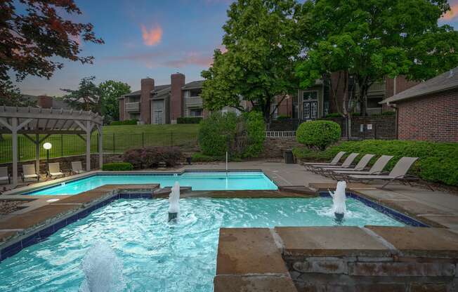A pool with a fountain in the middle of it.