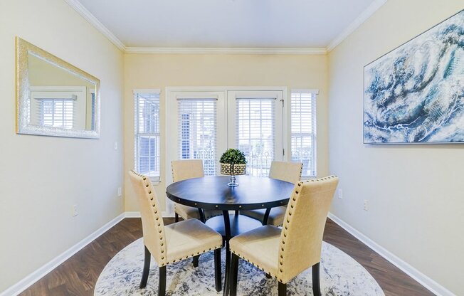 a dining room with a table and chairs