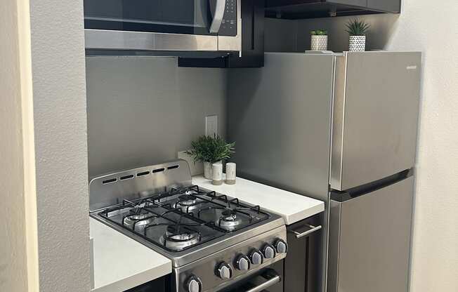 a kitchen with a stove and a microwave and a refrigerator