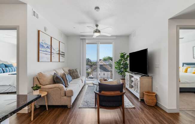 a living room with a couch and a chair and a tv