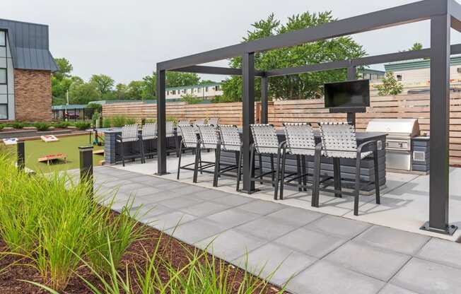 a patio with a table and chairs and a television