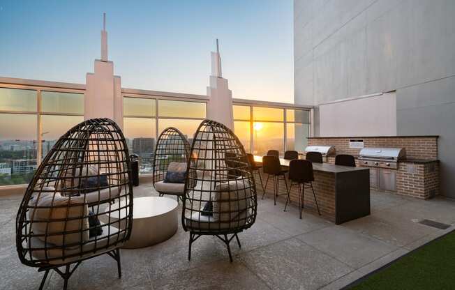 a living area with chairs and a table and a view of the city