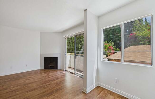 A room with a fireplace and a sliding glass door.