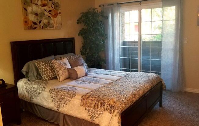 Bedroom With Expansive Windows at Citrus Gardens Apartments, Fontana, CA, 92335