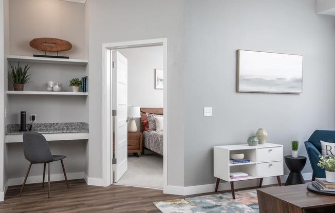 A room with a bed, a desk, and a chair.
