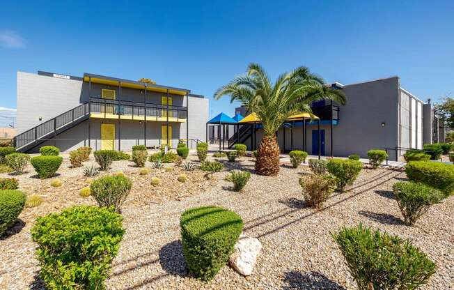 a house with a courtyard with palm trees and other buildings