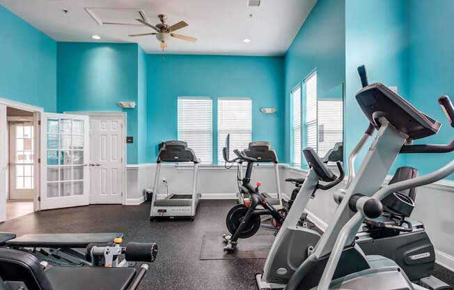 A spacious gym with a variety of exercise equipment.