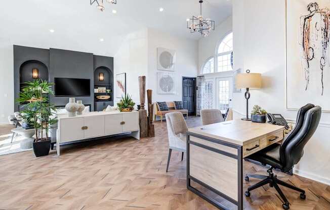 A modern home office with a wooden desk and black office chair.