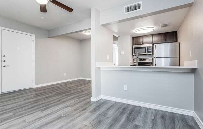 A kitchen area with a refrigerator, microwave, and oven.