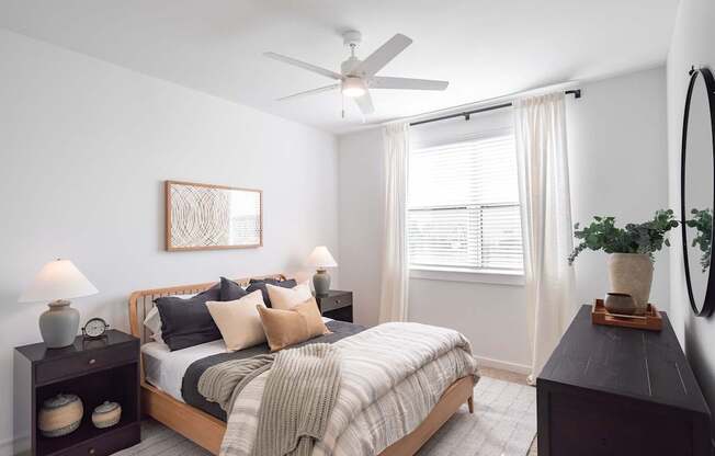 a bedroom with a bed and a ceiling fan
