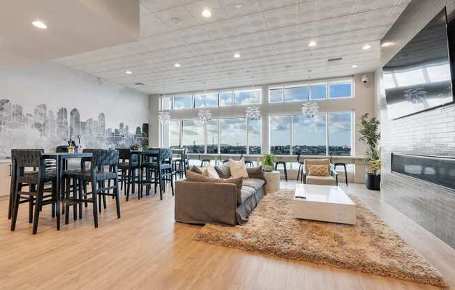 A spacious living room with a city skyline mural on the wall.