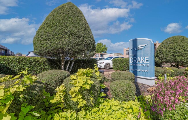 "The Drake Apartments" sign in front of a well-manicured garden at The Drake in Bossier City, LA