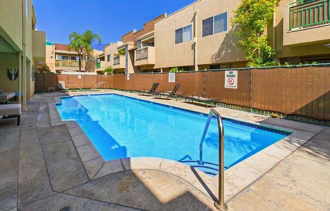 A pool with a no swimming sign on the fence.