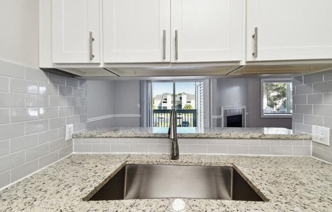 a kitchen with white cabinets and a sink