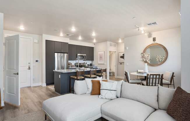 a living room with a white couch and a kitchen with a