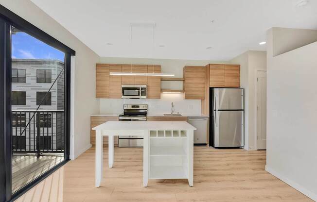 A modern kitchen with a white table and a refrigerator.