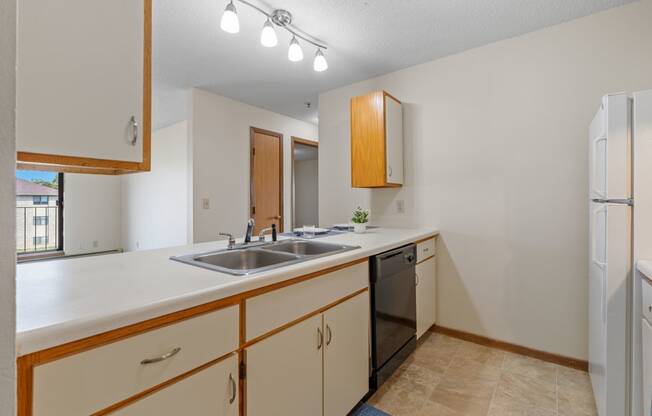 the preserve at ballantyne commons apartment kitchen with sink and refrigerator